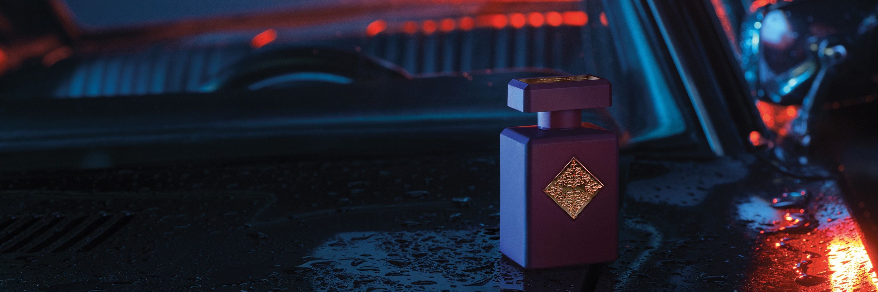 Perfume bottle with a decorative label on a car dashboard with neon lighting