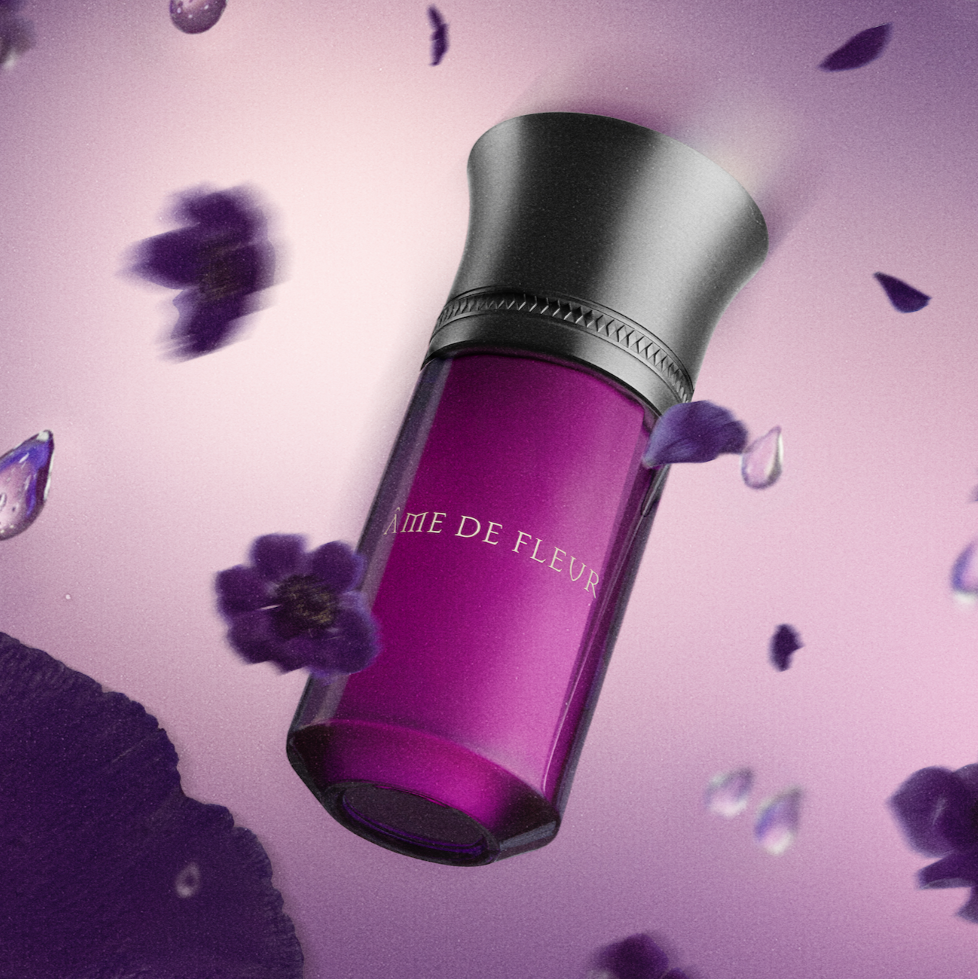 Purple perfume bottle with floral elements on a purple background