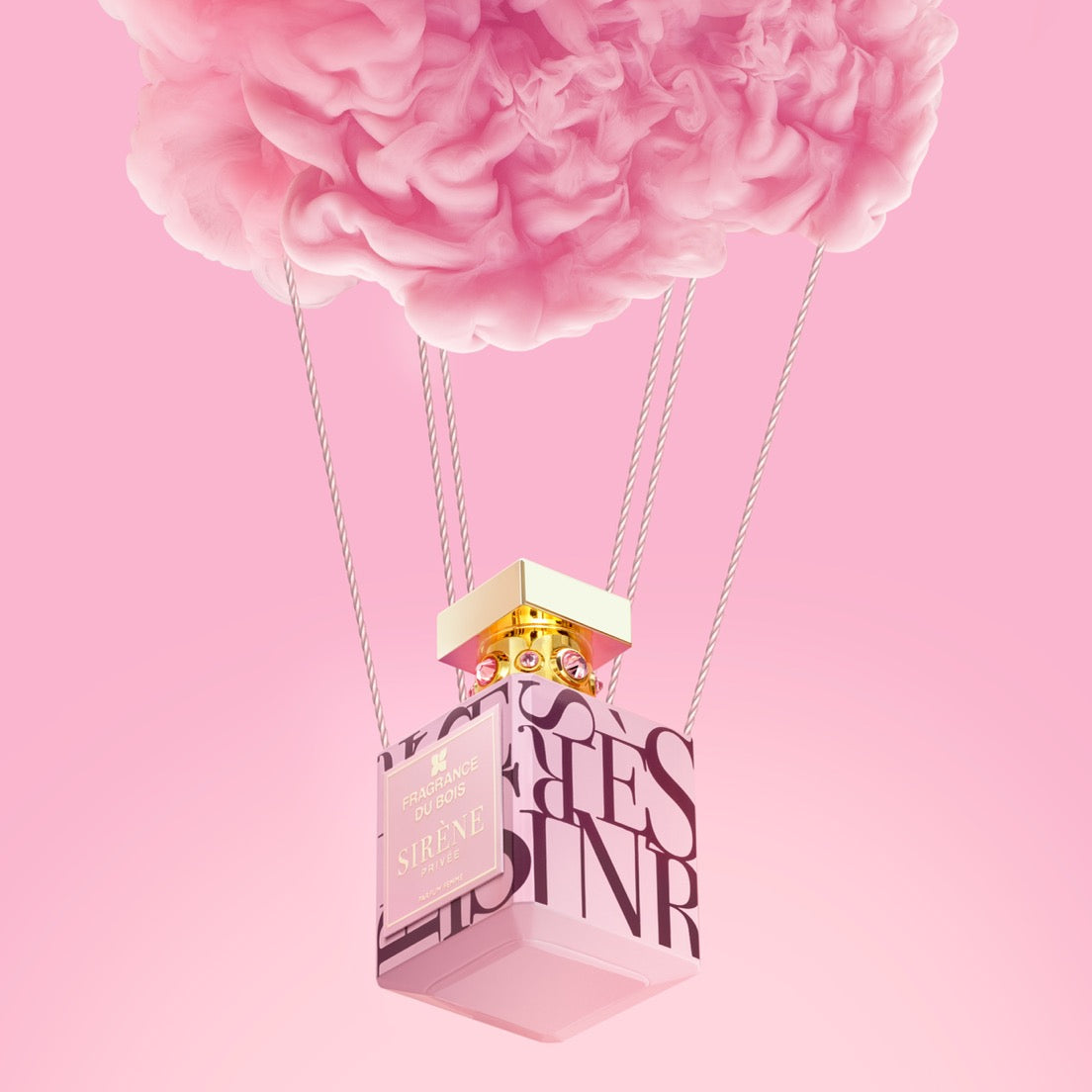 A pink perfume bottle labeled SIRIAE suspended by thin cords beneath a large pink cloud, set against a soft pink gradient background.